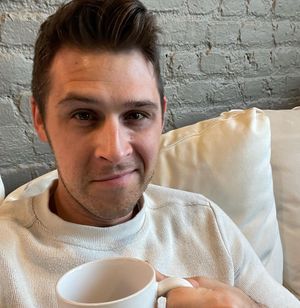 closeup of Zac Pitts holding coffee