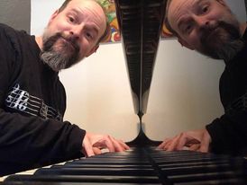 Josh Bradford seated, appropriately, at a piano