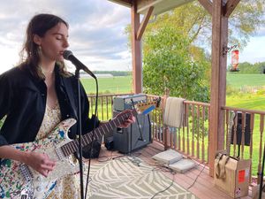 Rachel Rosen playing a paint splatted guitar