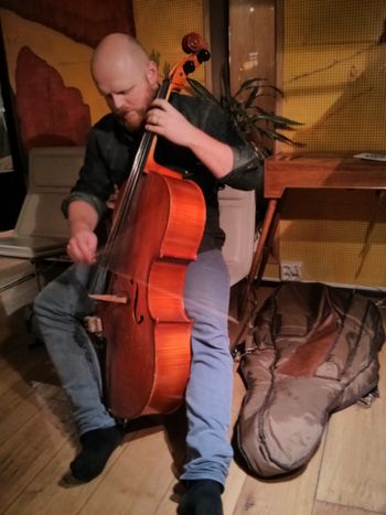 The bass player scales down and plays a cello built by his grandfather
