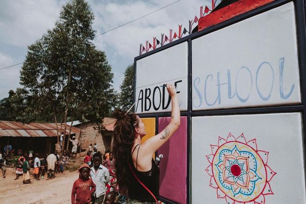 Charlotte Archer Painting Abode Project Mural in Uganda - Photo by Charlotte Robinson