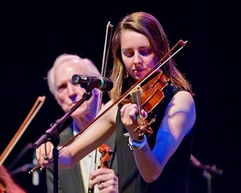 Marina performs at the 2015 National Fiddler Hall of Fame Gala as Byron Berline looks on.
