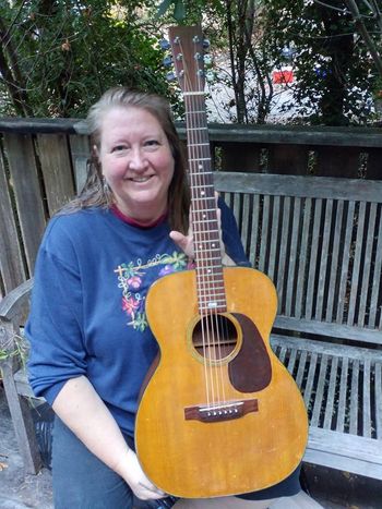 Gayle holding Kate Wolf's Martin Guitar

