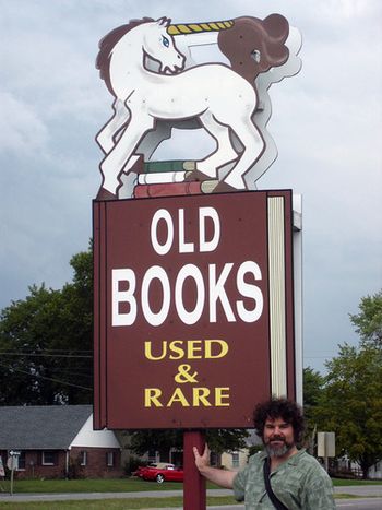 Steve Winick at the sign for The Unicorn Bookshop in Trappe, Maryland. Photo by Jennifer Cutting.
