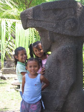 Local children and ancient sculpture
