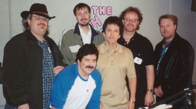 The Brian Linne Band at the WJR studios in 2005 where they appeared on The Mitch Albom Show. Brian is in the front (blue & white), Mitch Albom in center (beige shirt), the band in the back left to right, Rob Kandall (bass), Dave Taylor (drums), Dave Kujat (sax) and Robert Kerrigan (guitar).