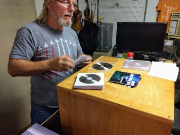 Dewayne helps put tigtther the new album CDs for an upcoming live show.
