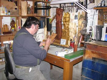Dave adding wood dye to a figure
