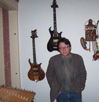 Paul Adams and instruments Standing in front of two instruments I made. The Koa Wood electric and my dark blue Electric Sitar heard on some of my albums
