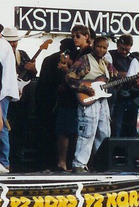 The Artist HUBERT TEMBA on stage (in visible jeans) rocking, doing a solo on his Fender Telecaster A
