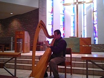 Peaceful harp music amidst the light of brightly colored windows, Reuben plays for the Gathering (Alzheimers support group) at Oak Knoll Lutheran Church
