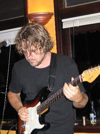 JL lost in his guitar (and hair)
