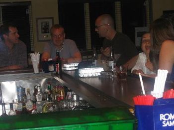 This photo is a little dark, but I like everyone's expressions around the bar.
