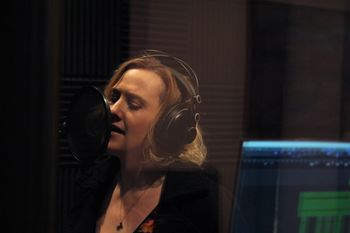 Holly Nicole Combs singing a vocal track.
