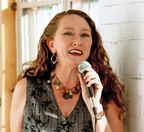 Sarah Clay singing into a microphone
