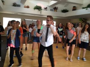 Crsig leads a group dance at elementary school