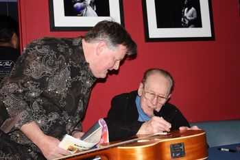 Les Paul signing my guitar and an article I wrote about him a few months before he died
