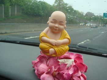 Sue's car Buddha watches over our traveling antics.
