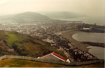 Aberystwyth, Wales, land of my fathers, overlooking Cardigan Bay.  That big hill in the distance is called Pen Dinas.
