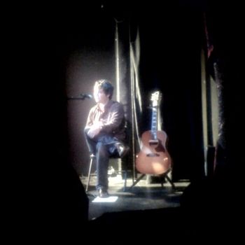 Joel and Guitar on Stage
