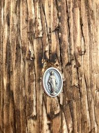 A Mary remembrance medal is placed on the back of each cross