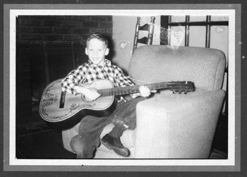 Kevin age 10 with first guitar
