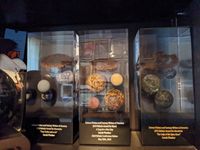 Three Nebula awards (blocks of lucite with a glitter galaxy swirl, and various planets made of different colored rock