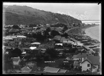 Looking down on the Esplanade along the Sumner waterfront from Scarborough with Cave Rock in the distance (right)1905
