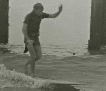 Guess who and where? Well, it's actually Dick Robinson...with one of those old diving wetsuits on with the horrible flap that we used to cut off ...and he's surfing a place called .....................!!!    looks soooooo much like Ken Beehre!!!!
