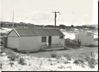 the Ruakaka SLSC humble beginnings 1961...the shed cost 10 pounds... after a big storm, we would have to dig the sand away from the doors to get into it.....how classic are those old cars!!!....that was a little weekend shop on the right.......ah..remember those early simple uncomplicated days of the early 60s!!...
