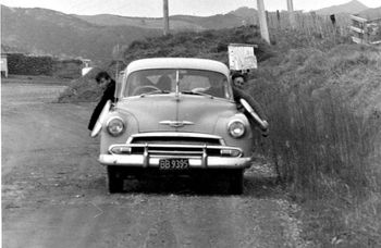 On the (metal) road...on the way to Langs...Summer of '64 Brother Phil driving the old mans cool chevy..we carried our boards all the way from Ruakaka to Langs & back like this..no roof rack..imagine doing that today..Ha!!..Mike Cooney (left)..Bill Prichard (right.head out window) & Brick Taylor (passenger seat)
