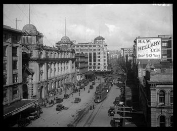 Looking up Queen Street from the ferry building on Quay Street West showing the entrances to the Auckland 1919
