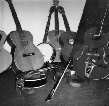 Late 1970s acoustic instrument collection. Syracuse, NY. I still have the mandolin, the fiddle and the Guild Starfire to the right.
