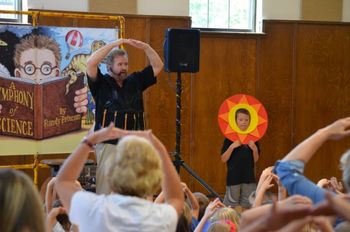 Mr. Sun, Sun, won't you please shine down on me? The audience helps out singing "Mr. Sun" to Mr. Sun at Randy's show at the Little Chute Public Library on July 16th
