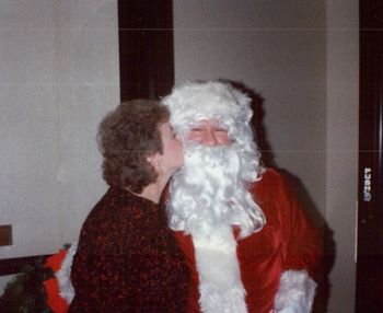 Mommy kissing Santa Claus 1996 Who is that guy under the beard?
