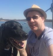 Stuart and his dog, Baskin, a long haired black Labrador, enjoying a sunny day on a pier at Kensington Metropark