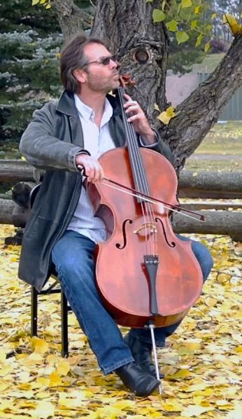 Cellist, Daniel Gaisford performing in Glacier National Park, Montana
