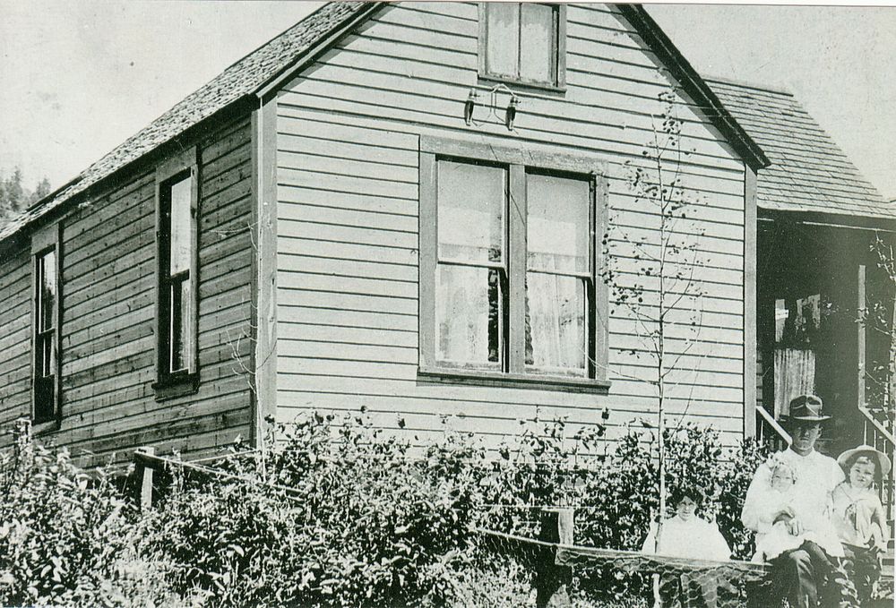 James Henry and Rose Amelia Lefevre in front of their home on Spokane St circa 1906.  Harry Lefevre is standing next to his father and Doris May Davies (nee Lefevre) is on her father's lap
