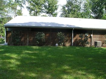 Right side of kennel. Runs are enclosed behind the privacy fence.
