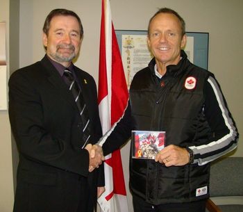 The Honorable Minister of International Trade, Stockwell Day receiving an commemorative CD from Dennis
