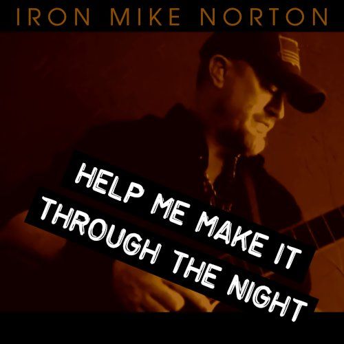 Image of Iron Mike Norton holding a guitar
