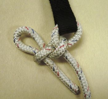 Go through the small loop end of the strap and tie a standard quick realease.
