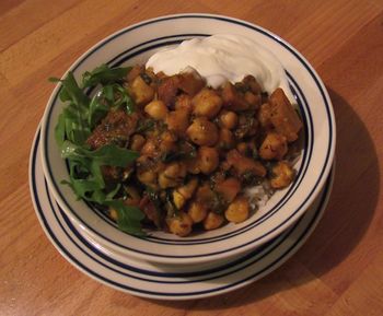 Curried Chickpeas with Potatoes on White Rice with Arugula
