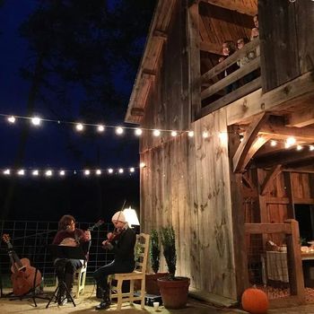 Corrie and I playing a House Concert  at Lamp Post Farm on a chilly fall night
