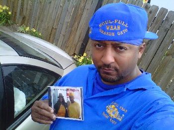J.O.T. aka GRANDE GATO holding 2010 CD album and wearing azul SOUL-FULL WEAR gear
