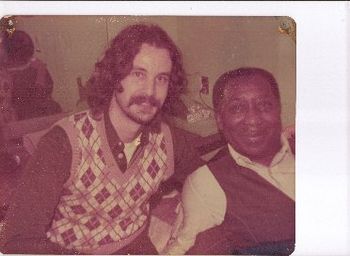 Bob Angell & Muddy Waters share a backstage moment in 1975
