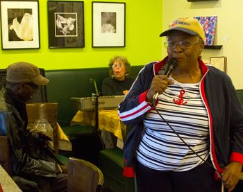 Larry Taylor watches Gloria Shannon sing with Bonni at Beverly Bakery, a stop in the 2015 Beverly Art Walk
