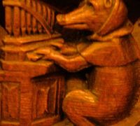 Porcine organist from a misericord carving now in the Musée de Cluny, Paris