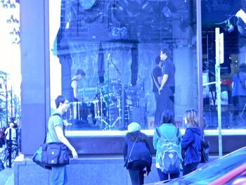 A band setting up in a store window.
