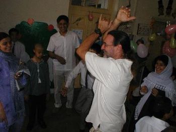 Larry dancing at school for disabled kids- Nadeem in background
